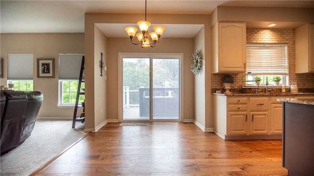 104 Cherokee Ct, Buffalo Twp But, PA 16229 - kitchen with a chandelier, backsplash, light wood-style floors, open floor plan, and dark stone counters