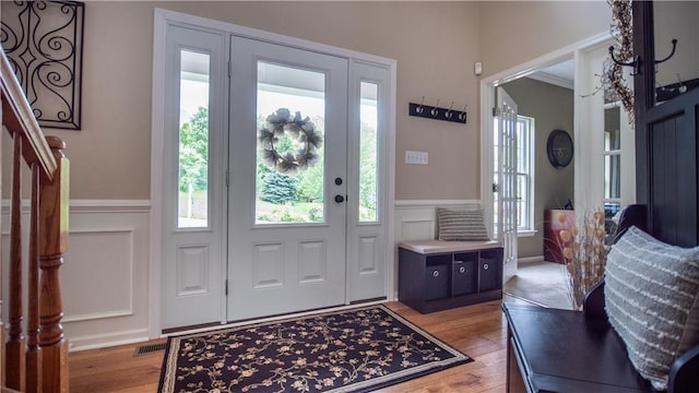104 Cherokee Ct, Buffalo Twp But, PA 16229 - entrance foyer with wainscoting, light wood-type flooring, stairs, and a decorative wall