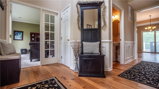 104 Cherokee Ct, Buffalo Twp But, PA 16229 - entryway featuring wood finished floors, a chandelier, a wainscoted wall, and ornamental molding