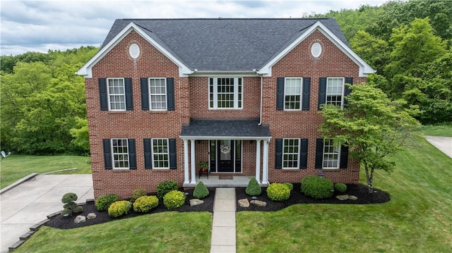 104 Cherokee Ct, Buffalo Twp But, PA 16229 - view of front of property with a shingled roof, brick siding, and a front yard