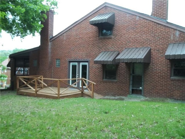 1545 Cooper Ave, Brighton Heights, PA 15212 - rear view of property with a chimney, a standing seam roof, a lawn, and brick siding