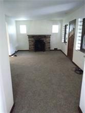 1545 Cooper Ave, Brighton Heights, PA 15212 - unfurnished living room featuring carpet, healthy amount of natural light, and a fireplace