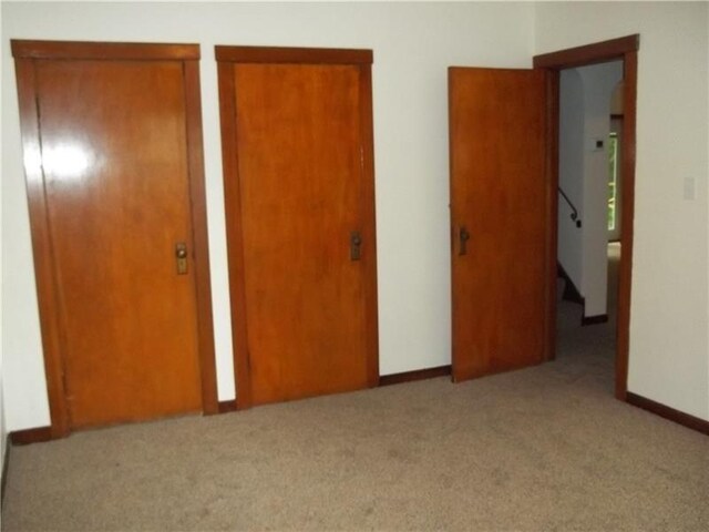 1545 Cooper Ave, Brighton Heights, PA 15212 - unfurnished bedroom featuring carpet flooring, baseboards, and two closets