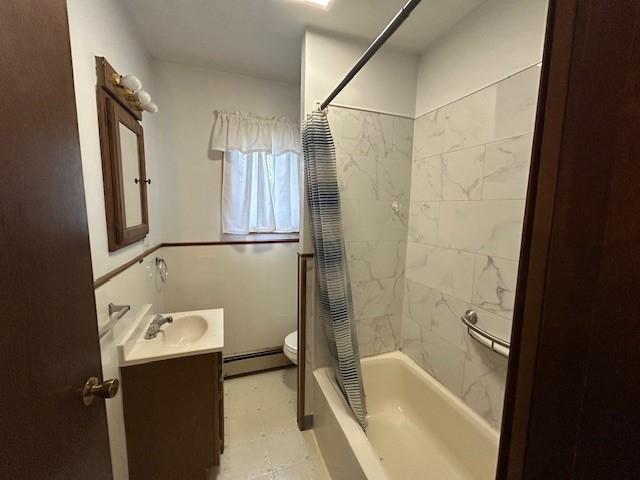 735 Park Ave, Johnstown, PA 15902 - full bath with a baseboard heating unit, toilet, vanity, and shower / bath combo with shower curtain
