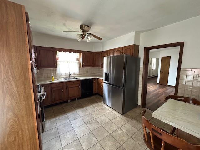 735 Park Ave, Johnstown, PA 15902 - kitchen featuring stainless steel refrigerator with ice dispenser, a sink, light countertops, a ceiling fan, and light tile patterned floors