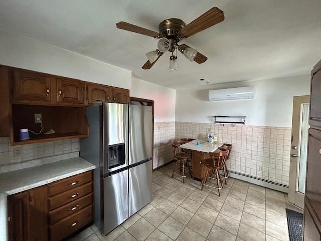 735 Park Ave, Johnstown, PA 15902 - kitchen with stainless steel fridge, an AC wall unit, a baseboard heating unit, tile walls, and ceiling fan