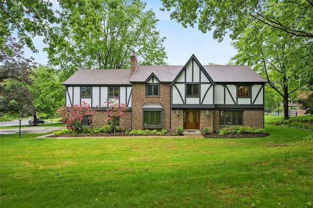 2465 Citation Ct, Franklin Park, PA 15090 - tudor home featuring a front lawn, a chimney, and brick siding