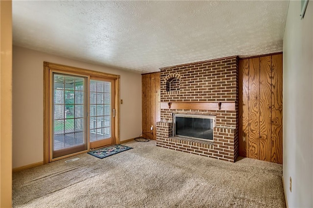 18 Giant Oak, Baden, PA 15005 - unfurnished living room featuring a textured ceiling, carpet floors, a brick fireplace, and baseboards