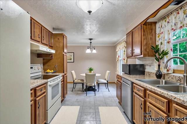 18 Giant Oak, Baden, PA 15005 - kitchen featuring white appliances, under cabinet range hood, a sink, brown cabinets, and light countertops