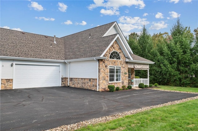 139 Canter Ln, West Deer, PA 15044 - view of front of house with stone siding, driveway, roof with shingles, and a garage