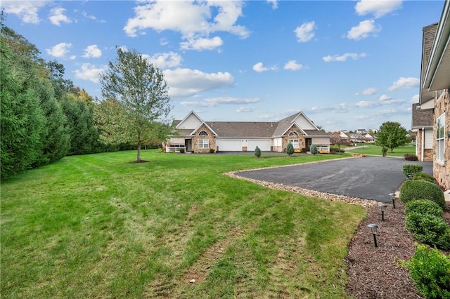 139 Canter Ln, West Deer, PA 15044 - view of grassy yard featuring asphalt driveway and an attached garage