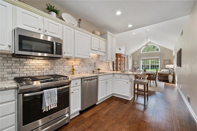 139 Canter Ln, West Deer, PA 15044 - kitchen with appliances with stainless steel finishes, a sink, a peninsula, dark wood-type flooring, and white cabinetry
