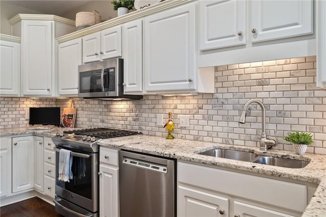 139 Canter Ln, West Deer, PA 15044 - kitchen featuring stainless steel appliances, a sink, white cabinetry, tasteful backsplash, and light stone countertops