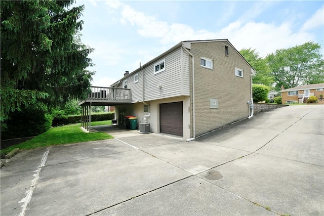 44 Eichelberger Dr, Robinson Twp Nwa, PA 15108 - view of side of home with a wooden deck, concrete driveway, a garage, and a lawn