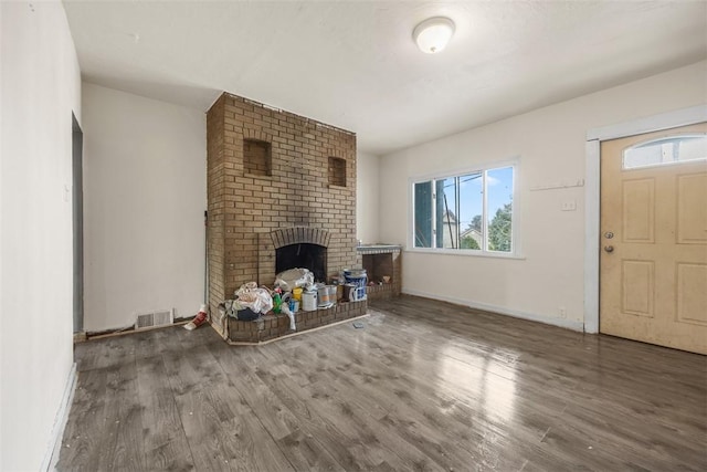 224 Moye Pl, Mount Oliver, PA 15210 - unfurnished living room with wood finished floors, plenty of natural light, and a fireplace