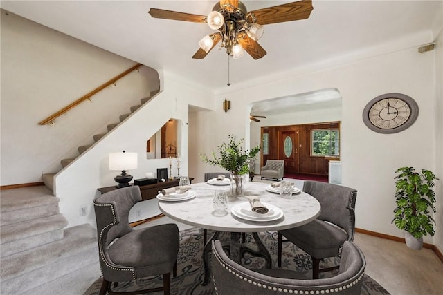 1303 Isabella Rd, Connellsville, PA 15425 - dining space with a ceiling fan, carpet flooring, stairs, and arched walkways