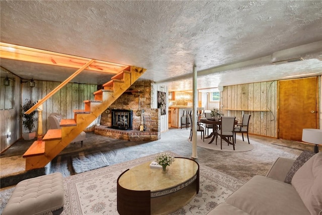 1303 Isabella Rd, Connellsville, PA 15425 - living area featuring wooden walls, stairs, carpet flooring, a textured ceiling, and a fireplace