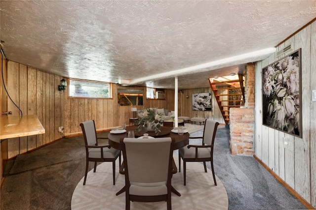 1303 Isabella Rd, Connellsville, PA 15425 - dining space with wood walls, light colored carpet, a textured ceiling, stairway, and baseboards