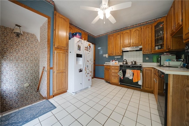 115 Orchard Ave, Rostraver, PA 15012 - kitchen with range with electric cooktop, white refrigerator with ice dispenser, under cabinet range hood, brown cabinets, and ceiling fan