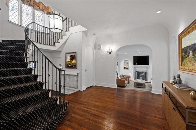 6820 Edgerton, Point Breeze, PA 15208 - entryway with wood finished floors, a textured wall, stairs, baseboards, and a fireplace