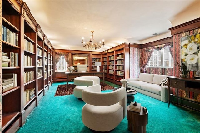 6820 Edgerton, Point Breeze, PA 15208 - living area featuring carpet floors, a chandelier, and bookshelves