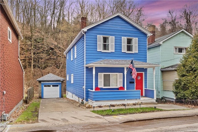 1320 Ravine St, Munhall, PA 15120 - view of front of home with an outbuilding, a chimney, concrete driveway, and a detached garage