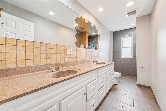 32 Norton St, Mt Washington, PA 15211 - bathroom with toilet, double vanity, tile patterned floors, tiled shower, and backsplash