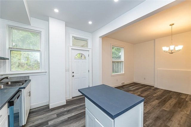 1044 Flemington St, Greenfield, PA 15217 - kitchen with dark countertops, a sink, a chandelier, white cabinetry, and dark wood-type flooring