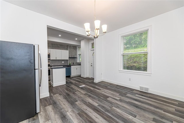 1044 Flemington St, Greenfield, PA 15217 - kitchen with stainless steel appliances, dark countertops, a chandelier, dark wood-style floors, and white cabinets