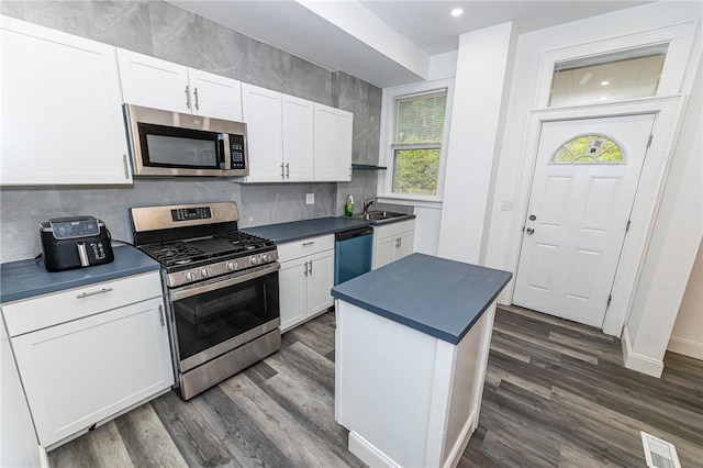 1044 Flemington St, Greenfield, PA 15217 - kitchen with stainless steel appliances, dark countertops, white cabinets, dark wood-style floors, and recessed lighting
