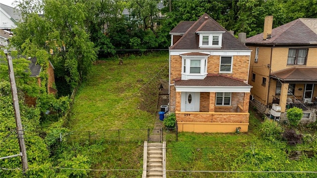 1044 Flemington St, Greenfield, PA 15217 - view of front of house with brick siding, roof with shingles, and a chimney