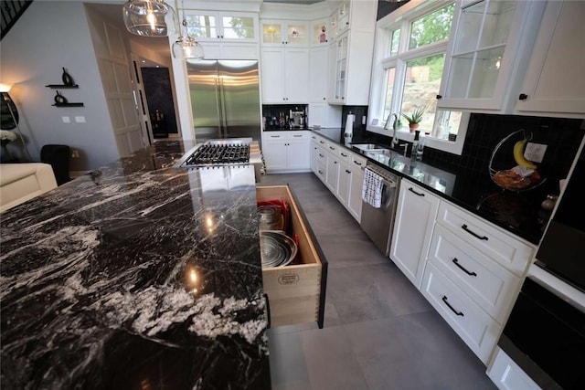 267 Reibold Rd, Forward Twp But, PA 16053 - kitchen with a sink, appliances with stainless steel finishes, decorative backsplash, and dark stone counters