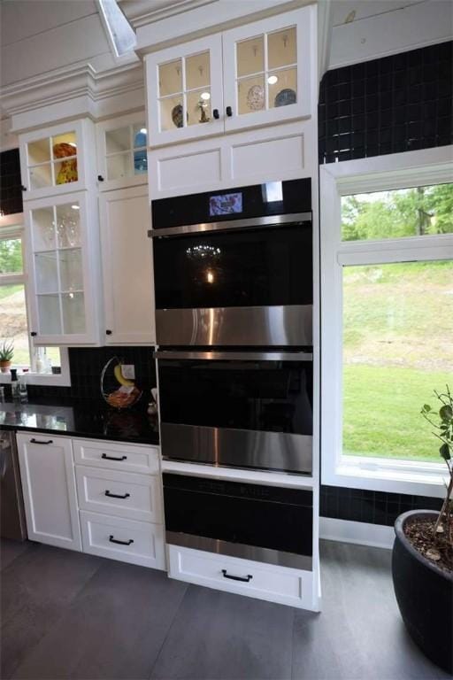 267 Reibold Rd, Forward Twp But, PA 16053 - kitchen featuring stainless steel double oven, white cabinetry, dark countertops, and glass insert cabinets