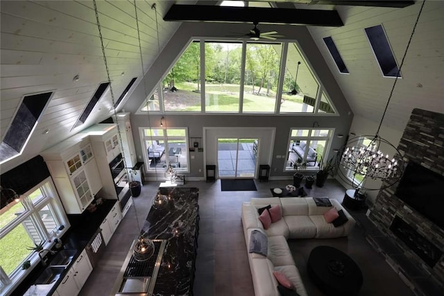 267 Reibold Rd, Forward Twp But, PA 16053 - living area with high vaulted ceiling, ceiling fan, beamed ceiling, and baseboards