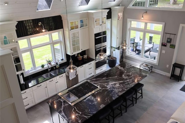 267 Reibold Rd, Forward Twp But, PA 16053 - kitchen with a sink, baseboards, white cabinets, glass insert cabinets, and stainless steel double oven