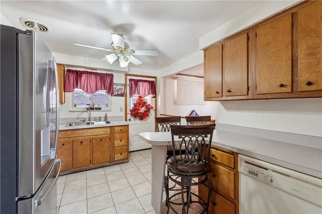 638 Friday Rd, Shaler, PA 15209 - kitchen featuring freestanding refrigerator, dishwasher, a sink, brown cabinets, and light countertops