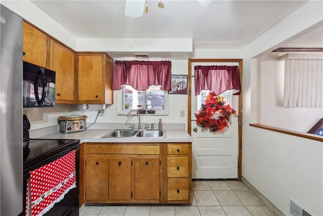 638 Friday Rd, Shaler, PA 15209 - kitchen featuring black appliances, a sink, brown cabinetry, light countertops, and light tile patterned floors