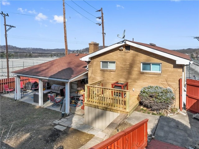 638 Friday Rd, Shaler, PA 15209 - rear view of property featuring a chimney, a patio, an outdoor living space, a deck, and brick siding