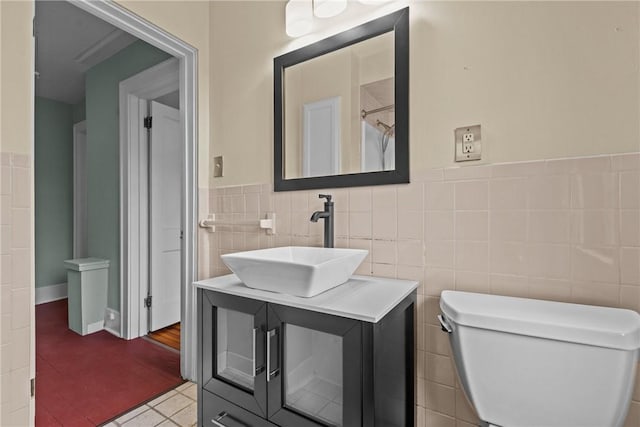 907 Greenfield Ave, Greenfield, PA 15217 - bathroom featuring tile walls, vanity, toilet, tile patterned flooring, and a wainscoted wall