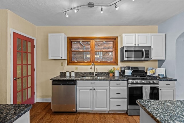 907 Greenfield Ave, Greenfield, PA 15217 - kitchen with appliances with stainless steel finishes, a sink, wood finished floors, and white cabinets