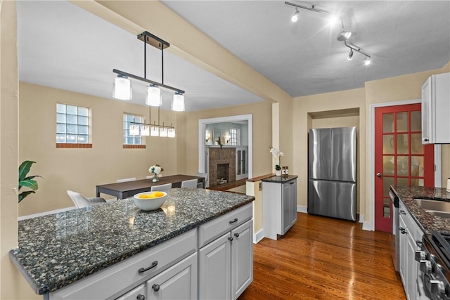 907 Greenfield Ave, Greenfield, PA 15217 - kitchen featuring appliances with stainless steel finishes, a sink, a fireplace, and white cabinets