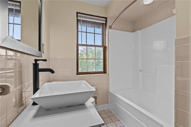 907 Greenfield Ave, Greenfield, PA 15217 - bathroom featuring a sink, tile walls, tile patterned floors, shower / tub combination, and wainscoting