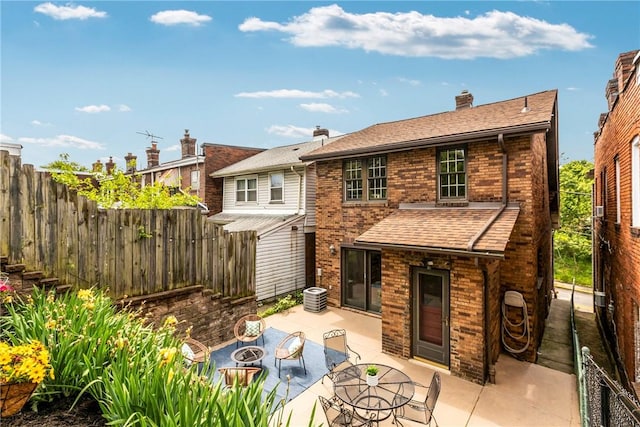 907 Greenfield Ave, Greenfield, PA 15217 - rear view of property with a fire pit, brick siding, a patio, and roof with shingles