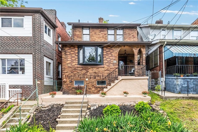907 Greenfield Ave, Greenfield, PA 15217 - view of front facade featuring brick siding, stairway, covered porch, and a chimney