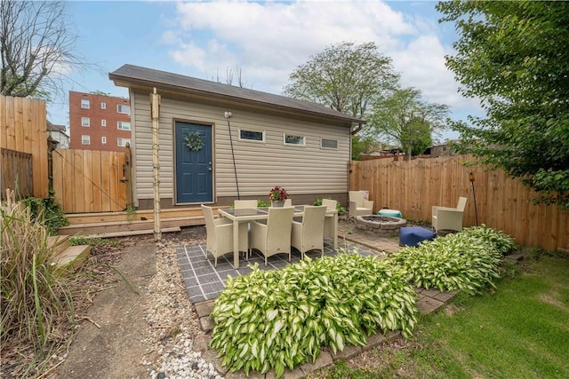 55 Evergreen Ter, Uniontown, PA 15401 - back of property featuring a fenced backyard, a fire pit, and a patio