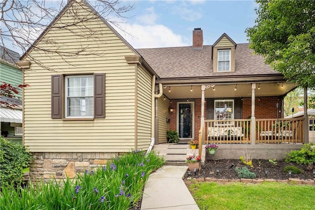 55 Evergreen Ter, Uniontown, PA 15401 - view of front of home with covered porch, roof with shingles, a chimney, and brick siding