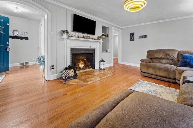 55 Evergreen Ter, Uniontown, PA 15401 - living room featuring a fireplace, ornamental molding, wood finished floors, baseboards, and arched walkways
