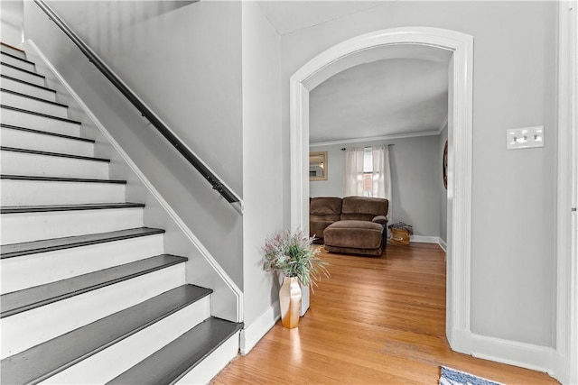 55 Evergreen Ter, Uniontown, PA 15401 - stairs featuring baseboards, crown molding, wood finished floors, and arched walkways