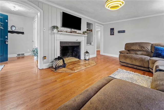 55 Evergreen Ter, Uniontown, PA 15401 - living room with ornamental molding, light wood finished floors, a fireplace, baseboards, and arched walkways