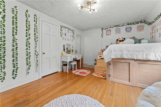 55 Evergreen Ter, Uniontown, PA 15401 - bedroom with wood finished floors, baseboards, and a chandelier